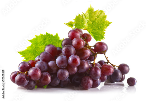 Valokuva Bunch of ripe red grapes with leaves isolated on white