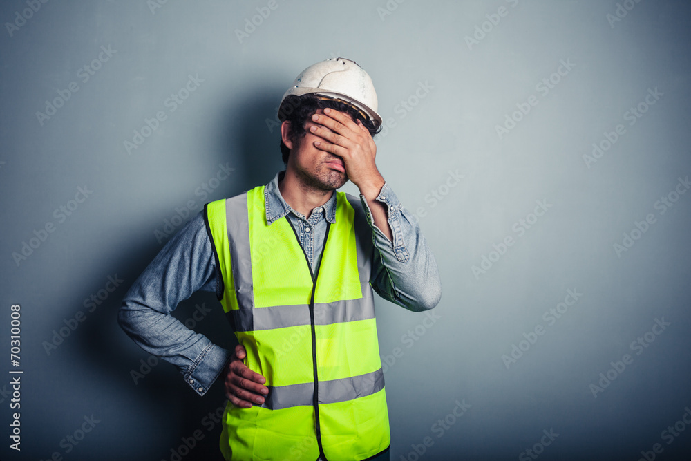 Engineer in high vis covering face Engineer in high vis covering face
