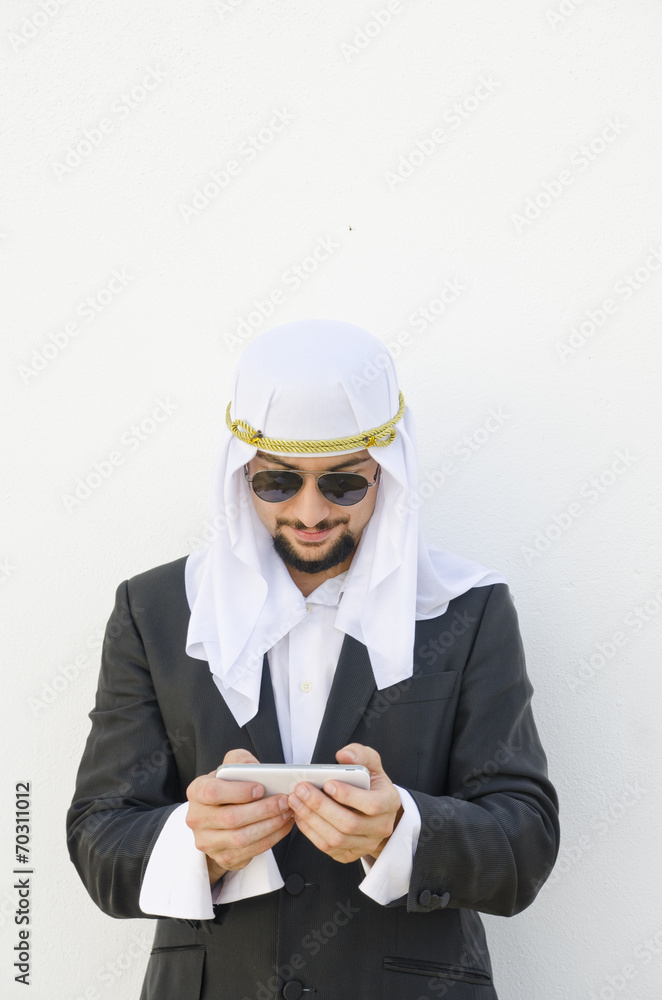 Arab man touching smartphone Arab man touching smartphone