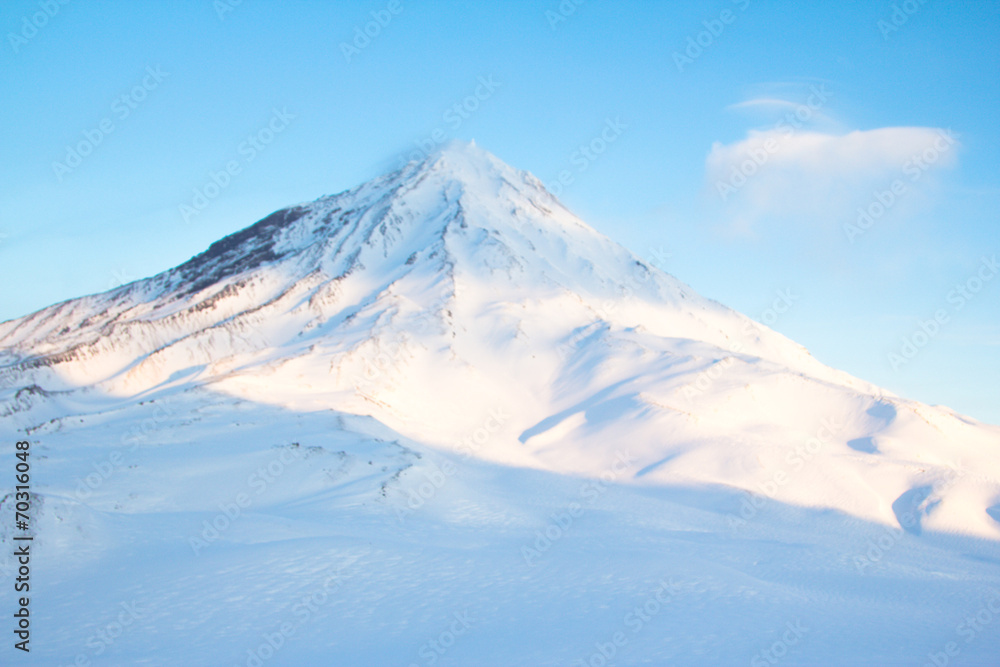 Winter landscape in the mountains with blue sky in the clouds