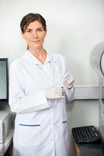 Researcher With Blood Sample For Coagulation Analysis photo