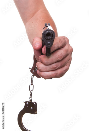 male hand in police handcuffs and a gun isolated