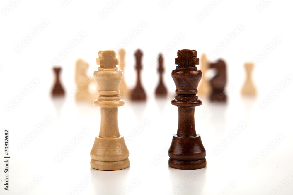 chess pieces lined up in a row on a gray chess pieces lined up in a row on a gray