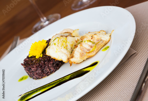 Hake with black rice and sauce