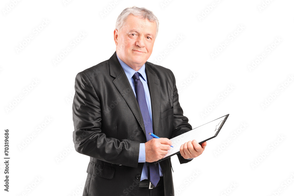 Mature businessman taking notes on piece of paper Mature businessman taking notes on piece of paper