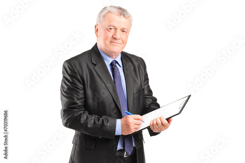 Mature businessman taking notes on piece of paper © Ljupco Smokovski
