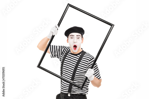 Mime artist holding a big picture frame