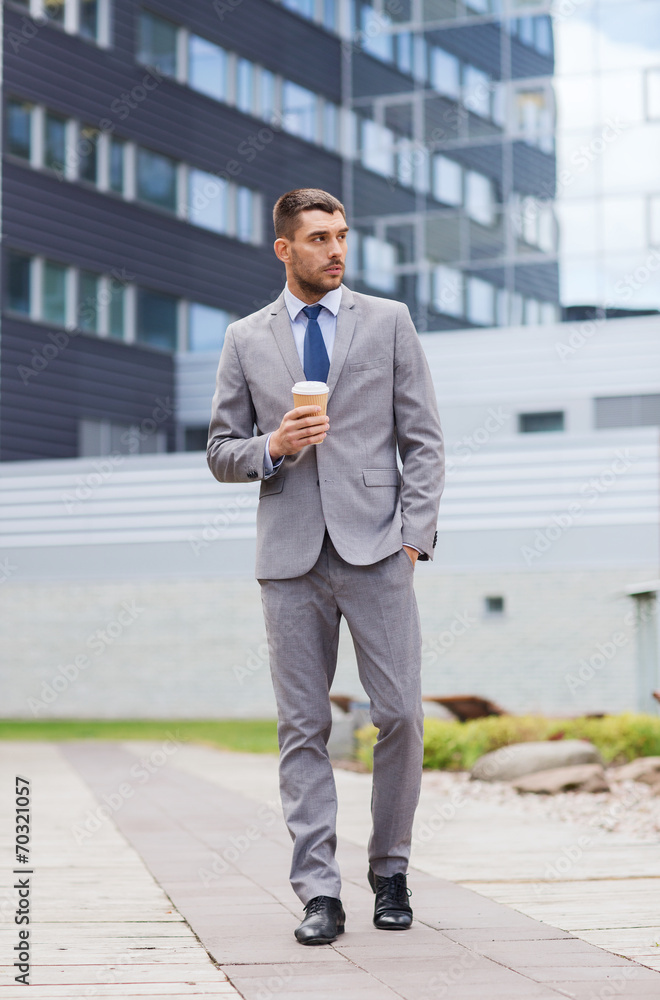 young serious businessman with paper cup outdoors young serious businessman with paper cup outdoors