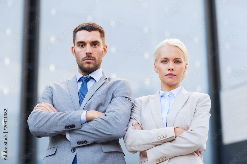 serious businessmen standing over office building serious businessmen standing over office building