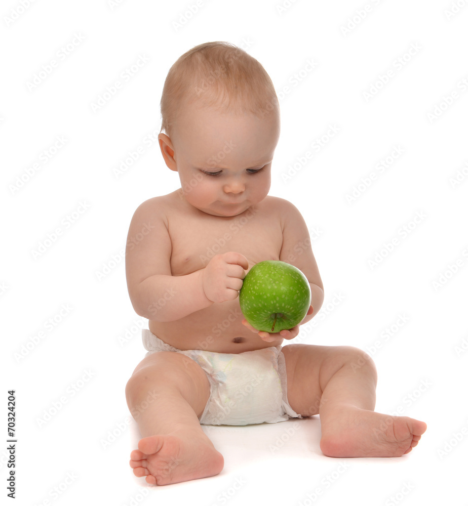 Infant child baby toddler sitting in diaper with green apple Infant child baby toddler sitting in diaper with green apple