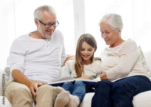smiling family with book at home