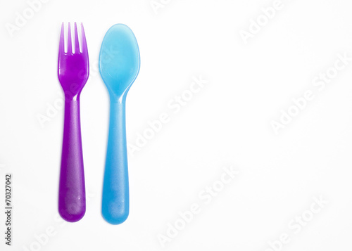 Colorful fork and spoon isolated on white with copyspace