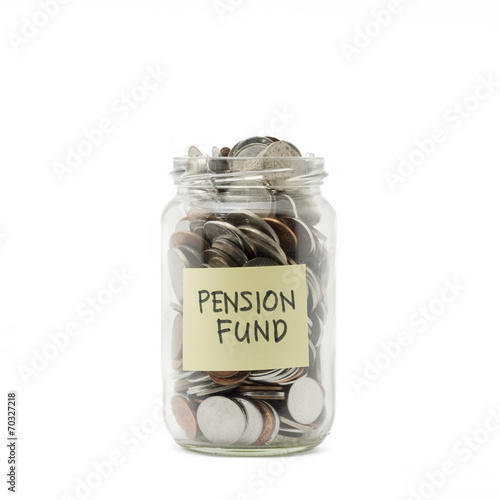 Isolated coins in jar with pension fund label