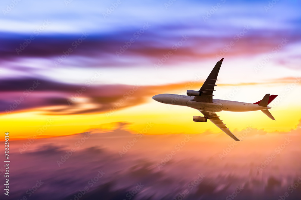Airplane in the sky at sunrise Airplane in the sky at sunrise
