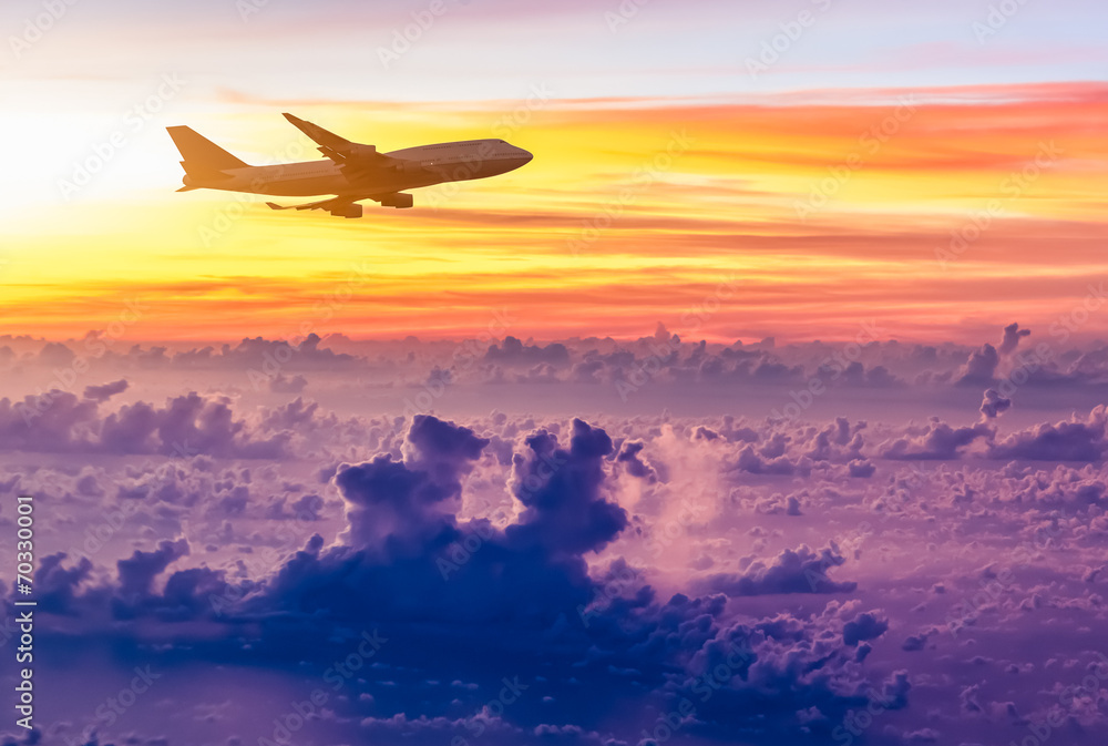 Airplane in the sky at sunrise Airplane in the sky at sunrise