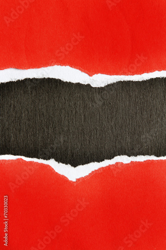Torn red paper on black background © Stillfx