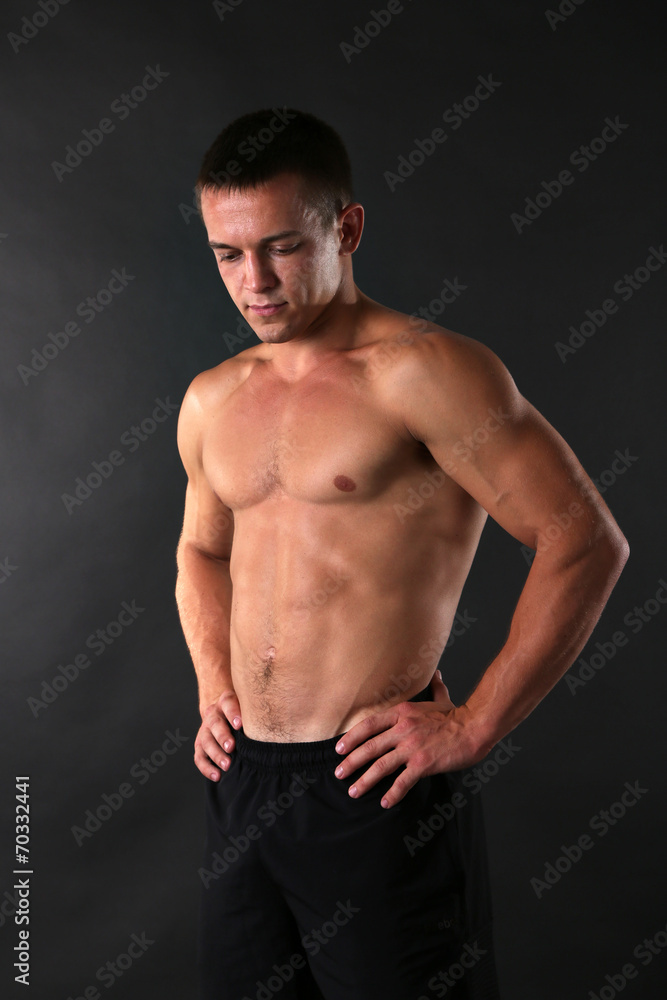 Handsome muscle young man on dark background