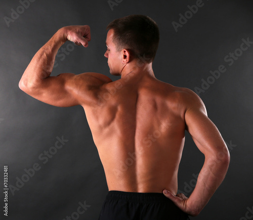 Handsome muscle young man on dark background