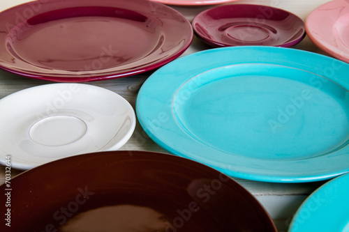 Different plates on wooden background