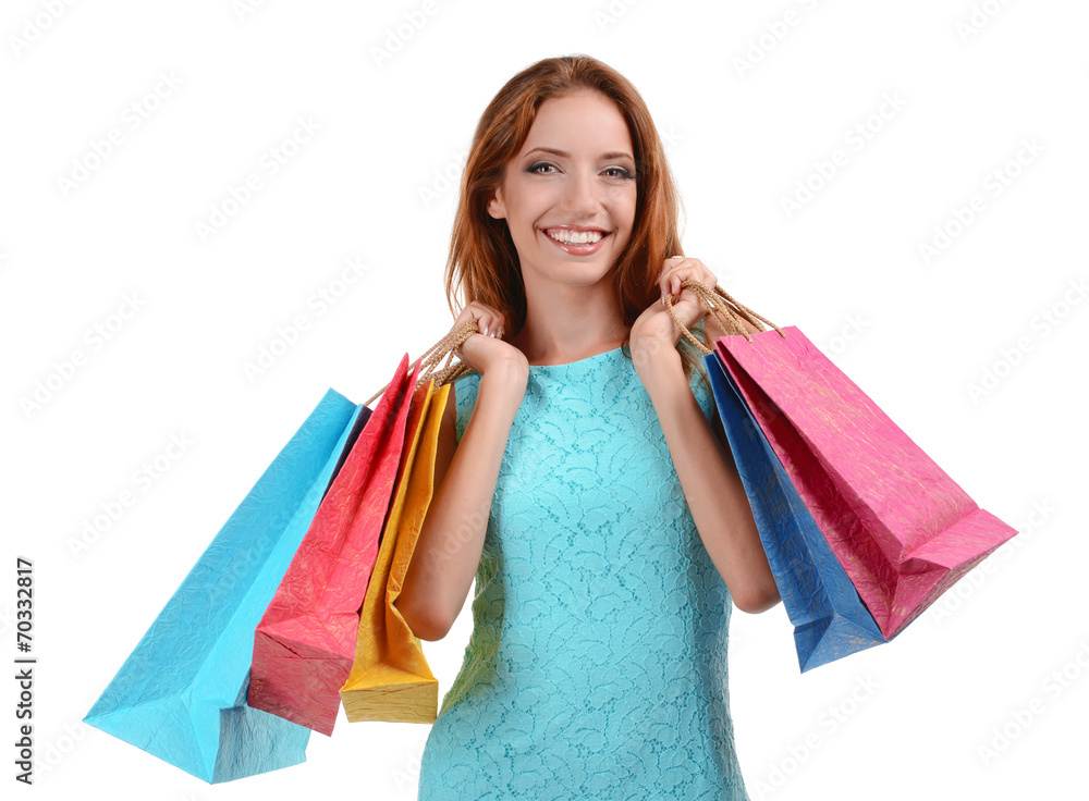 Beautiful young woman with shopping bags isolated on white