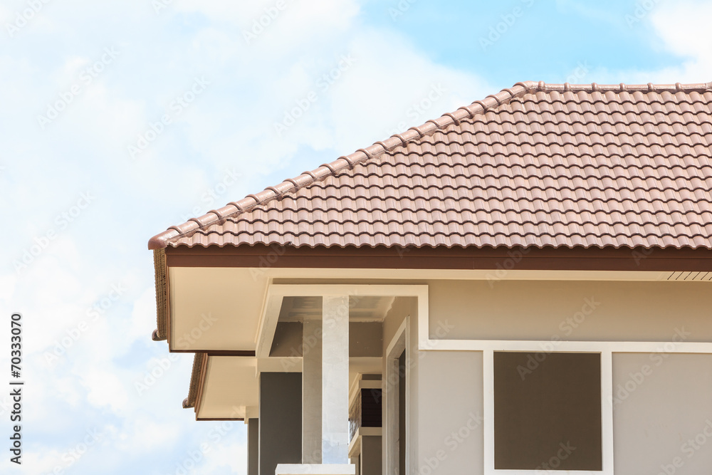 roof under construction with stacks of roof tiles for home build