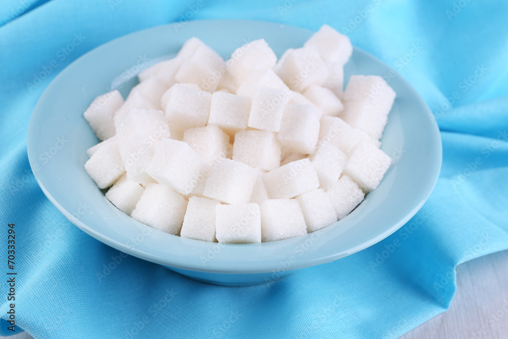 Refined sugar in color bowl on wooden background Refined sugar in color bowl on wooden background