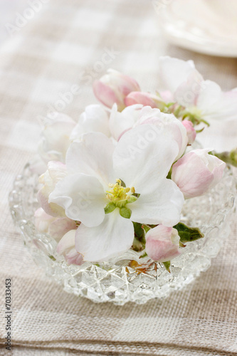 Table decoration of blooming apple tree flowers in crystal bowl © agneskantaruk