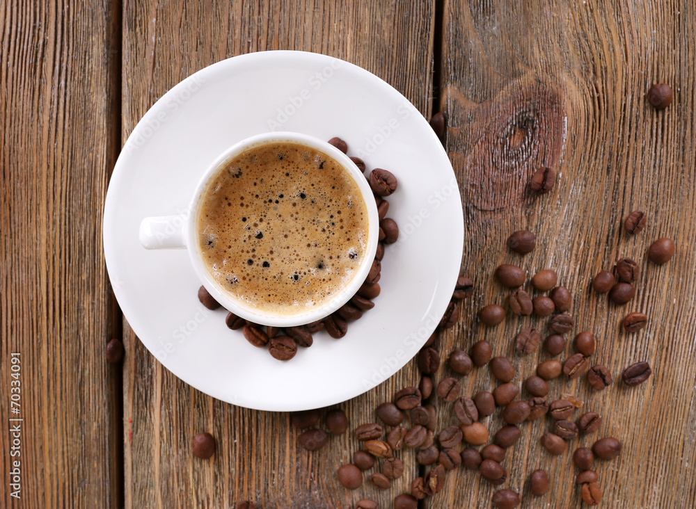 Cup of coffee with milk and coffee beans on wooden background Cup of coffee with milk and coffee beans on wooden background