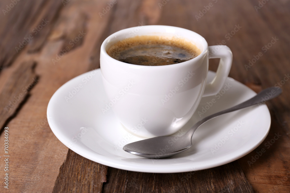 Cup of coffee on wooden background