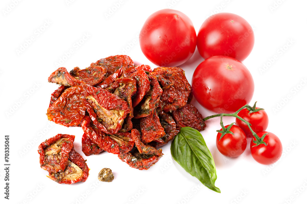 Sun dried tomatoes with basil and ripe tomatoes, isolated on whi Sun dried tomatoes with basil and ripe tomatoes, isolated on whi