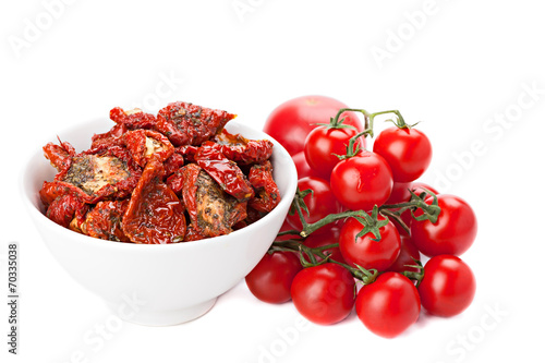 Sun dried tomatoes and ripe tomatoes, isolated on white. photo