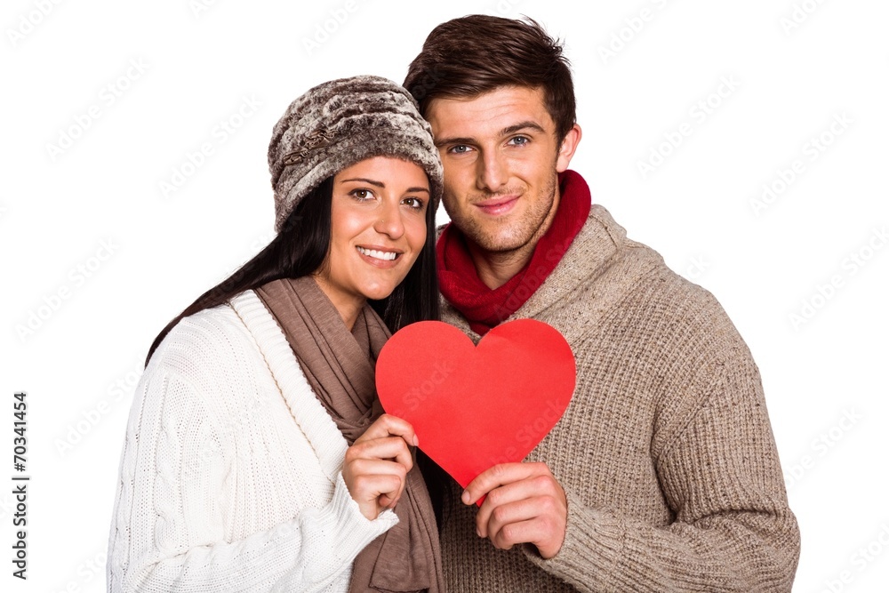 Young couple smiling holding red heart