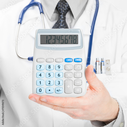 Doctor holdling in his hand calculator - 1 to 1 ratio photo