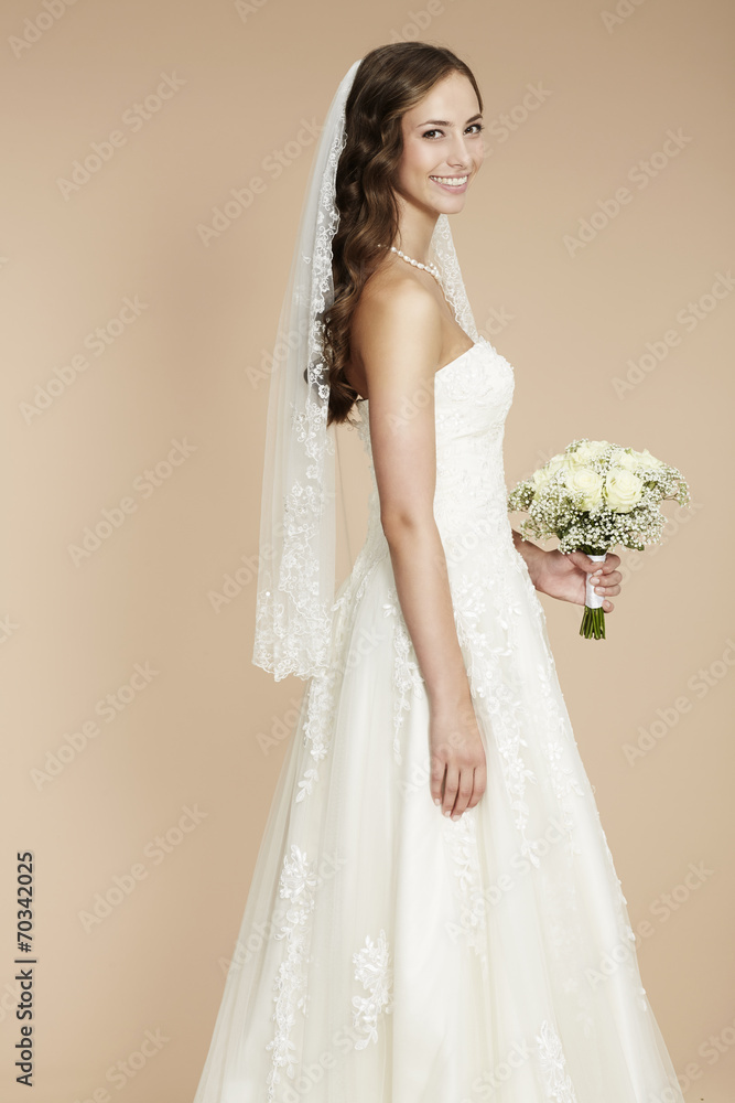 Elegant young bride in wedding dress, studio shot. Elegant young bride in wedding dress, studio shot.