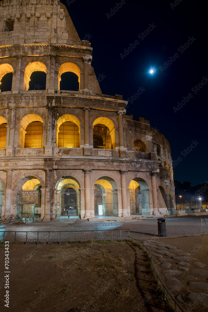 Colosseum by night with moon