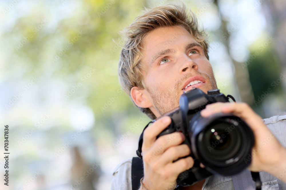 Photographer shooting outside with digital camera Photographer shooting outside with digital camera