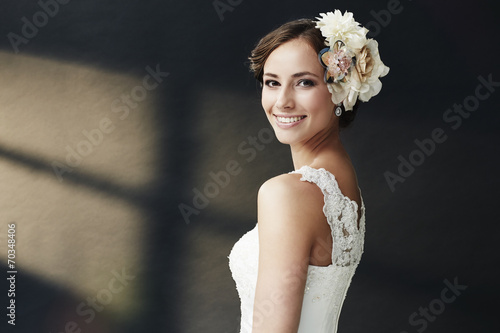 Glamorous young bride in wedding dress, smiling. photo