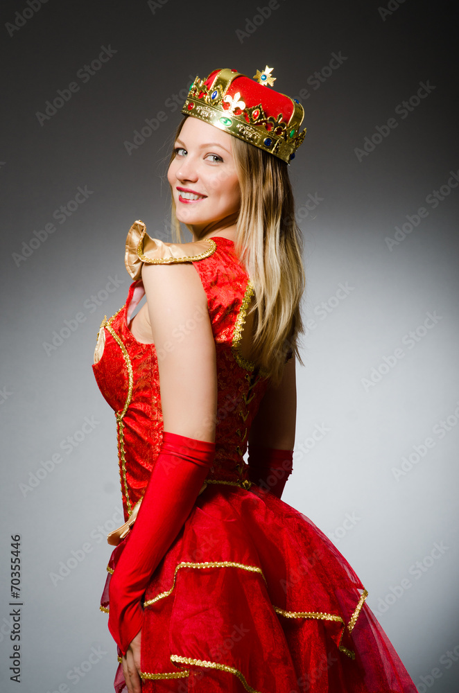Queen in red costume against dark background