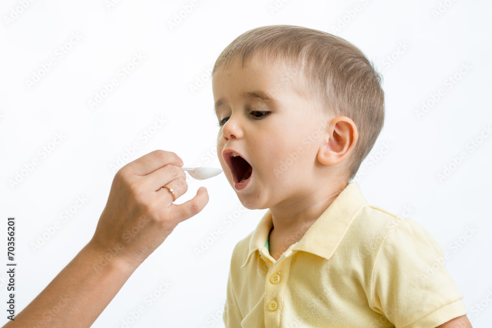 doctor giving remedy feeding with a spoon doctor giving remedy feeding with a spoon