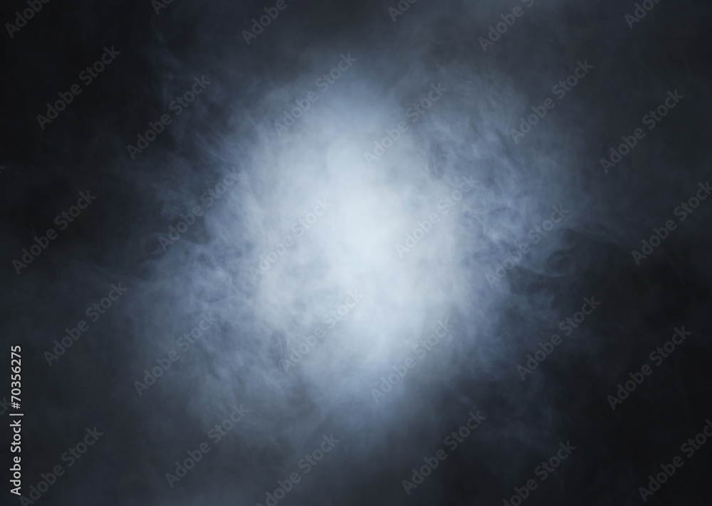 Obraz premium Light blue smoke on a black background