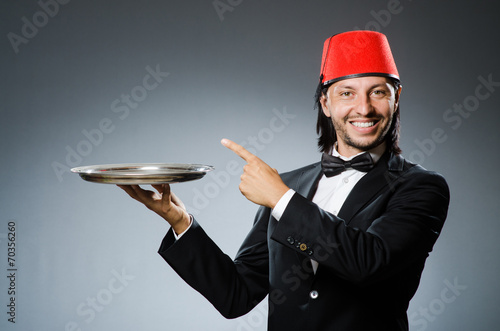 Waiter wearing traditional turkish hat photo