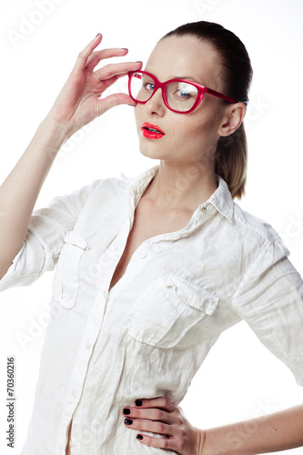 Business woman in glasses and a bright white shirt on a white ba