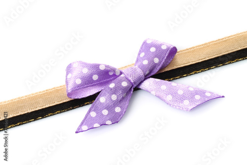 Big retro purple holiday bow on white background .