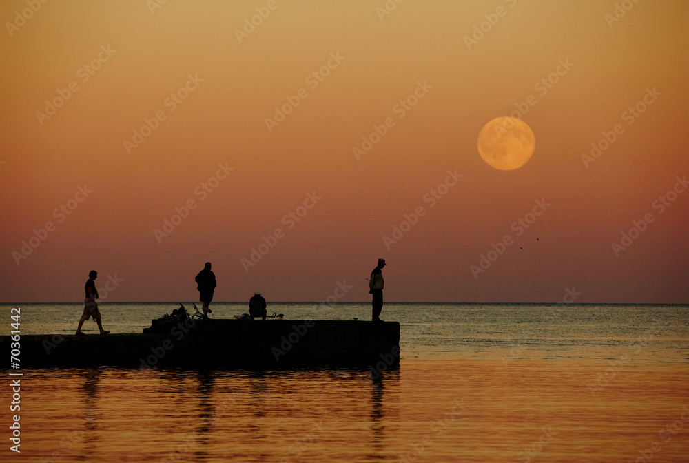 sea sunset with large moon