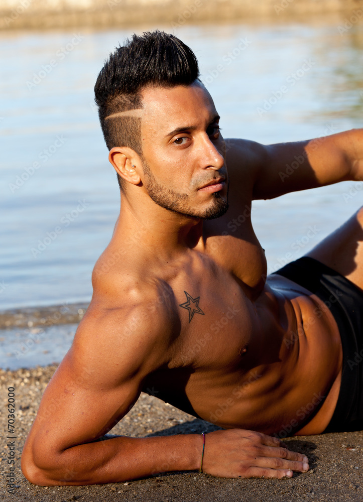 Handsome muscular man on the beach. Handsome muscular man on the beach.