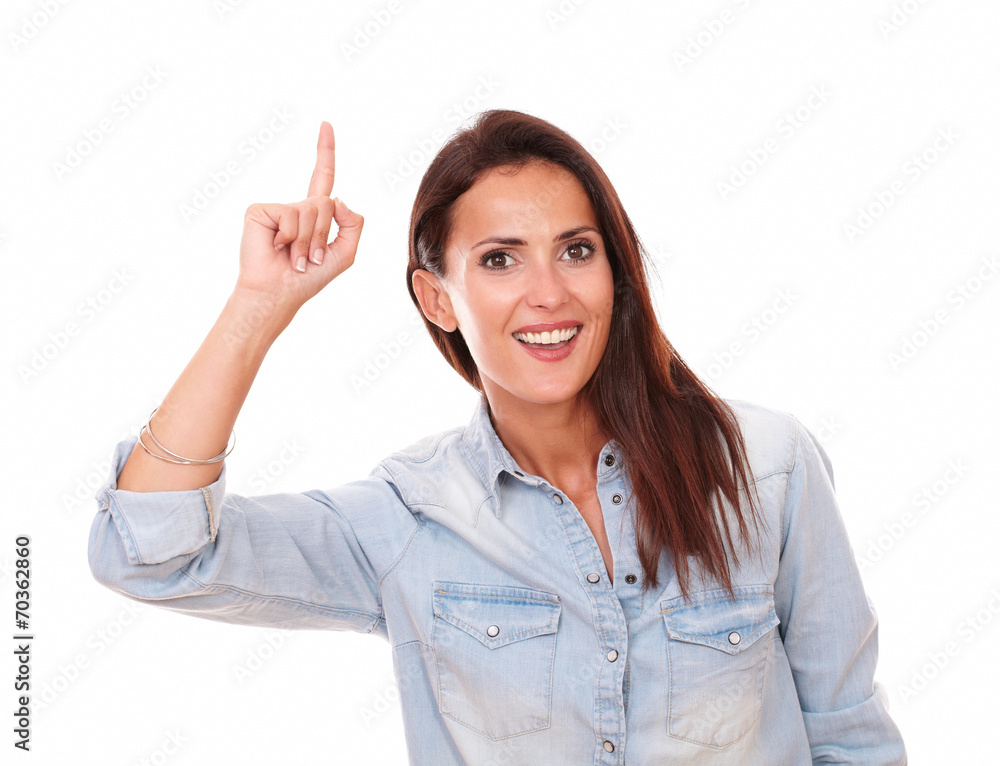 Pretty hispanic lady pointing up and smiling Pretty hispanic lady pointing up and smiling