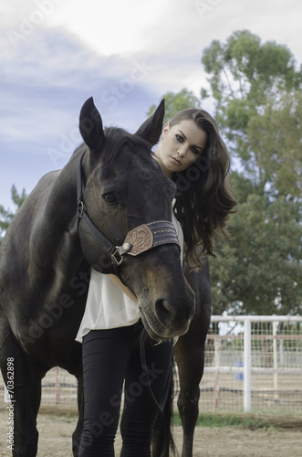 Beautiful young woman and her horse