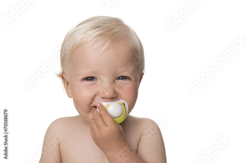 One year old boy with dummy smiling