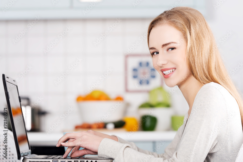 Young woman using a laptop computer at home Young woman using a laptop computer at home