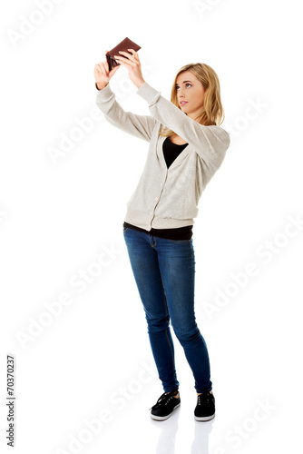 Young caucasian woman with empty wallet
